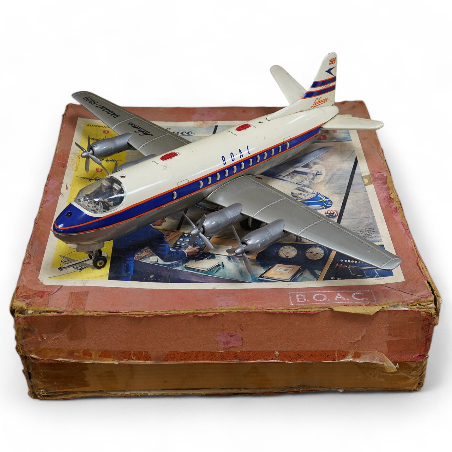 A boxed Schuco Elektro Radiant 5600 battery operated tinplate BOAC passenger aircraft, with instruction leaflet and steering wheel. Condition - poor to good, wear and damage to box and some tape repairs, aircraft general